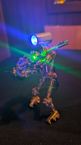 Customer's assembled Terminator M model, shown with its glowing blue headlamp and green arm light.