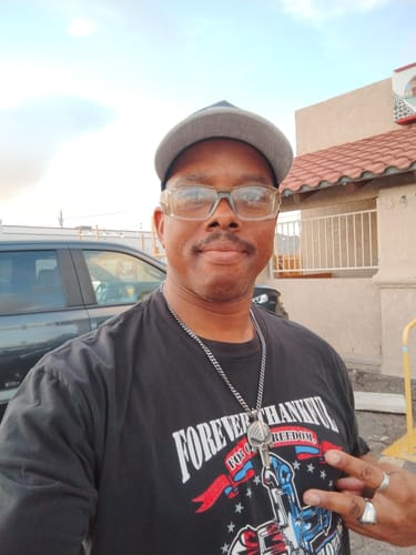 Reviewer wearing the Vindicta Vengeance Without Mercy Necklace over a graphic t-shirt.