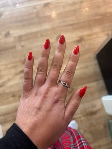 Customer showing the silver Love Knot Ring worn on a hand with red nails.