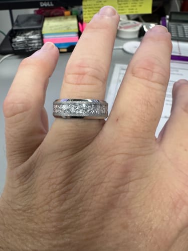 Customer's hand wearing the Aureum Silver ring, showing the wide band and textured inlay.