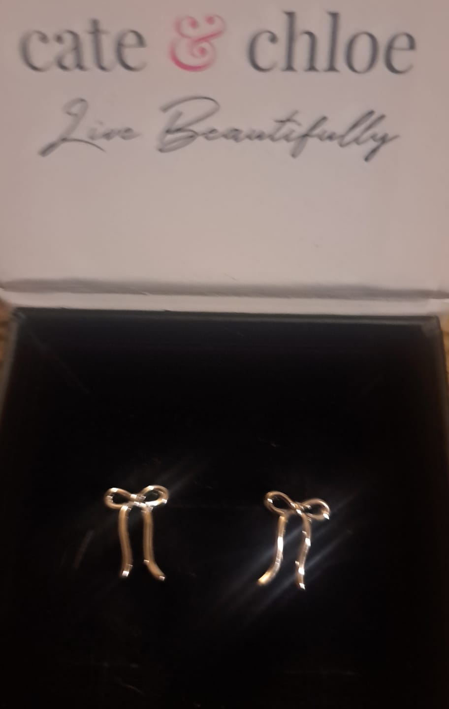 Customer photo review of Lola 18k White Gold Plated Ribbon/Bow Drop Earrings