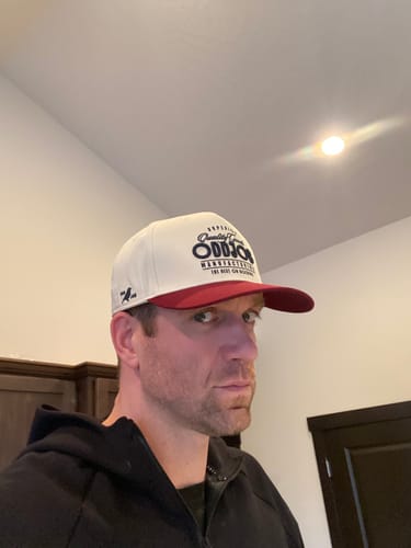 Reviewer wearing a white Big Structured A-Frame Hat with a red bill and front logo.