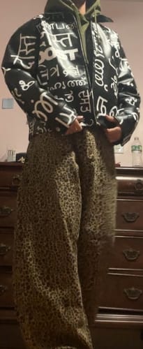 Reviewer wearing the Cheetah Print Barrel Pants, showing the wide-leg fit with a jacket and hoodie.