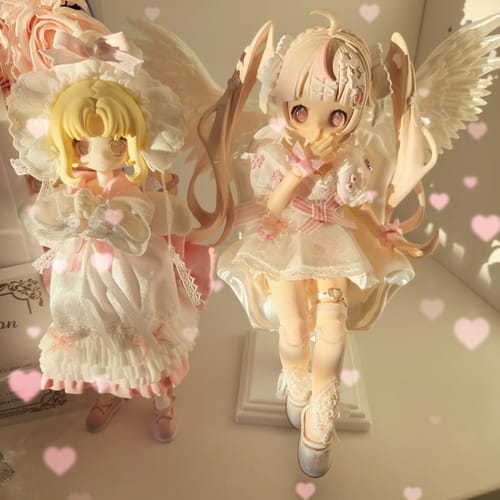 Reviewer's Meki Aipo action figure with pink hair and wings displayed next to a second, similar doll.