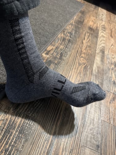 Close-up of a customer wearing the gray Men's Alpaca Socks, showing the side view and textured black ankle support.
