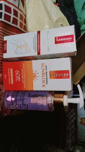 Customer displays the complete Melasma Bundle, including the cream, sunblock, and face wash.