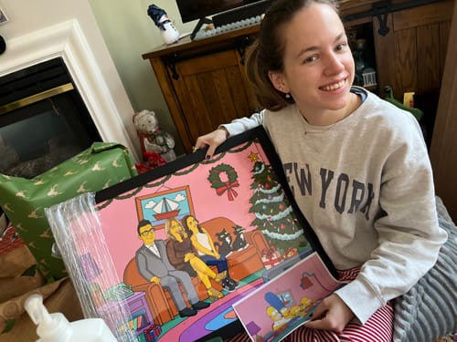Customer happily holding their custom cartoon Framed Horizontal Poster on Christmas morning.