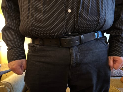 Customer showing the fit of the black Everyday belt worn with dark jeans and a button-down shirt.