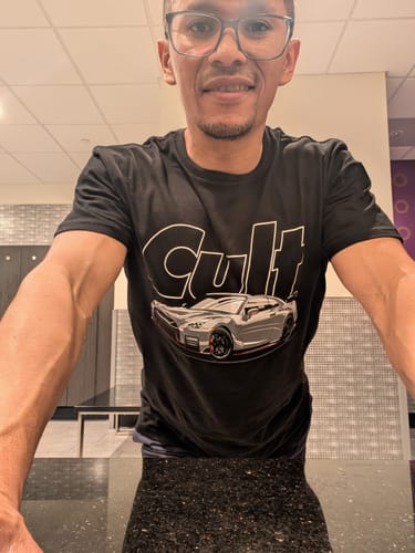 Customer wearing a black MYSTERY TEE with a silver car graphic and 'Cult' text.