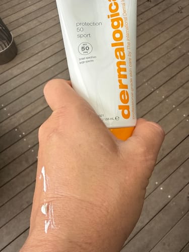 Reviewer showing the white texture of protection 50 sport spf50 sunscreen on the back of their hand.