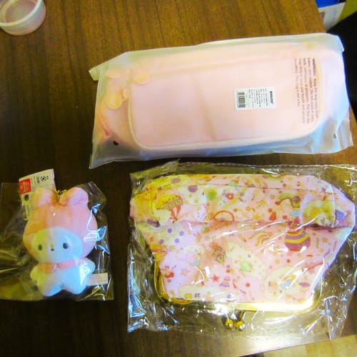 Customer's My Melody Pendant Plushie in its packaging, shown with two other purchased items on a table.
