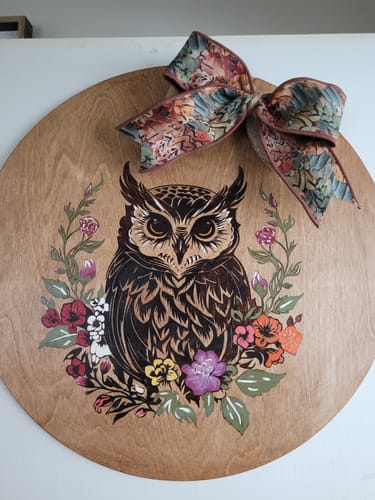 Reviewer's beautiful artwork created with Scorch Paint, showing a burned owl on a round wooden plaque with floral accents.