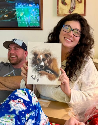 Customer smiling while holding her personalized photo painting, which features a portrait of a dog.