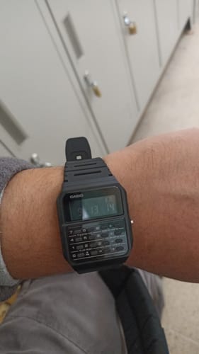 Cliente usando el Reloj Calculadora Casio negro en su muñeca.