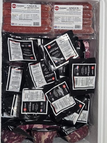 Customer's Quarter Beef Bundle showing various vacuum-sealed beef cuts and franks inside a cooler.