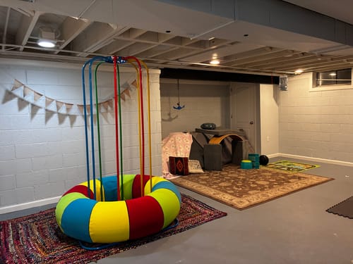Customer's colorful Jungle Jumparoo set up in their basement playroom.