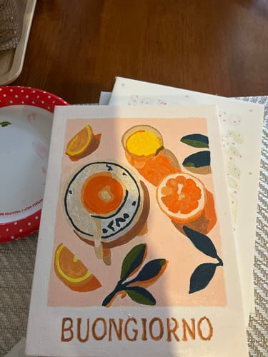 Reviewer's completed paint-by-numbers canvas from the La Dolce Vita bundle, showing a colorful scene with oranges and 'Buongiorno'.