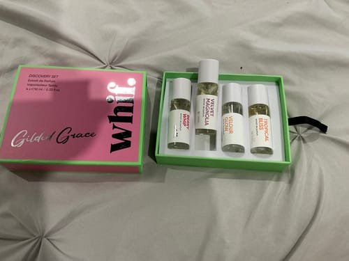 Customer's Whif Discovery Set with its pink and green box open, showing four small fragrance bottles inside.