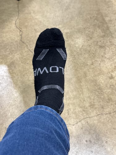 Customer's close-up of the black Men's Alpaca Sock on their foot, showing the grey pattern.