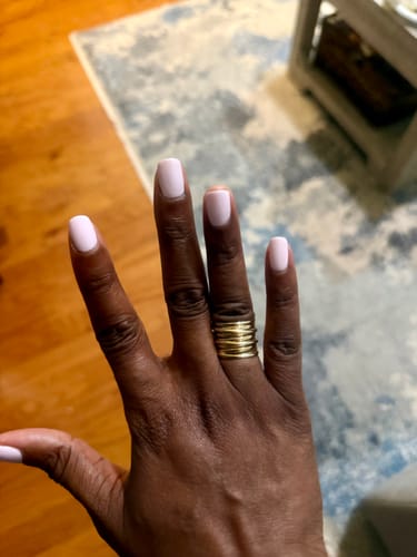 Customer's hand wearing the gold-plated Chunky Wrap Wide Band Ring.