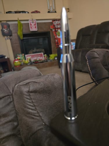Customer's silver Bullet Antenna standing upright on a table indoors.