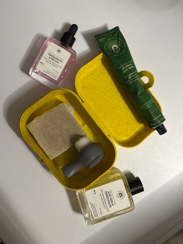 Customer's Harmony Routine products, including cleanser, toner, serum and moisturiser, on a white surface.