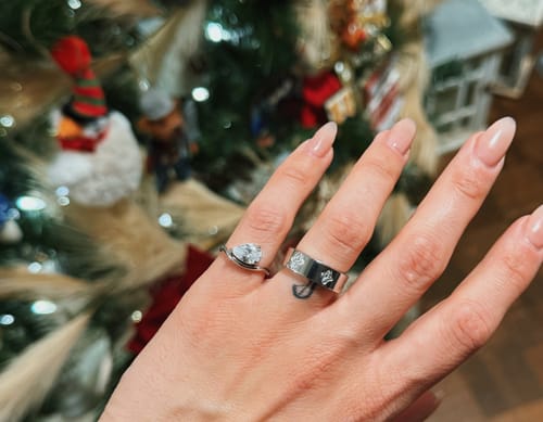 Reviewer's hand wearing the wide Eloise Ring, showing the patterned platinum plated band.