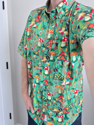 Reviewer wearing the colorful Willy Wonka 'Pure Imagination' shirt, showing the fit and candy-themed pattern.