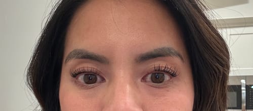 Close-up of a reviewer's eyes after a first-time application of 10mm cluster lashes, showing the result.