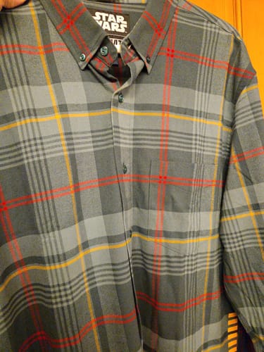 Close-up of the reviewer's grey plaid Star Wars flannel shirt with red and yellow accent stripes.