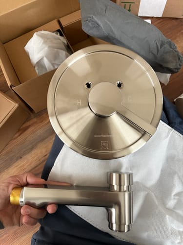 Reviewer showing the beautiful, solid hardware components of the 3-Spray Dual Shower Head Set.