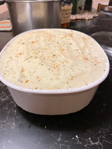 Customer's delicious Shepherd's Pie, made with Ground Lamb, in a white dish on a countertop.