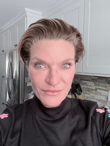 Customer's selfie showing a rosy, smooth complexion after using the Grass Fed Tallow & Manuka Honey Balm.