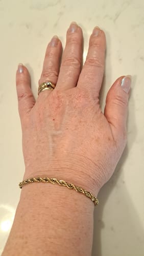 Customer wearing the gold Rope Bracelet on their wrist.