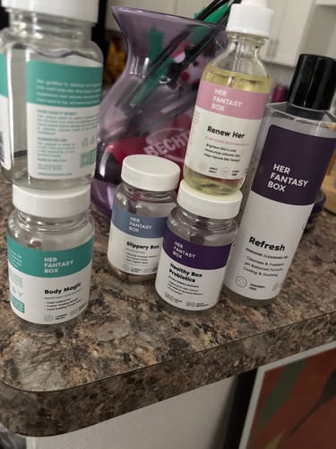 Customer's Her Fantasy Box products including Body Magic, Probiotics, and Refresh wash on a countertop.