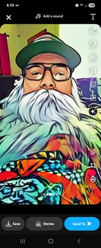 A stylized selfie from a reviewer with a long white beard and glasses.