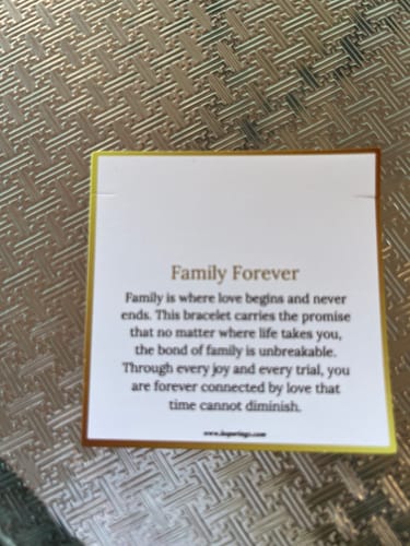 Reviewer shows the message card for the Friends Forever Bracelet, which incorrectly reads 'Family Forever'.