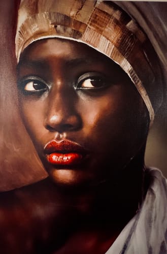 Customer's African Woman Painting Wall Art showing a close-up portrait of a woman with a patterned headwrap and vibrant red lips.