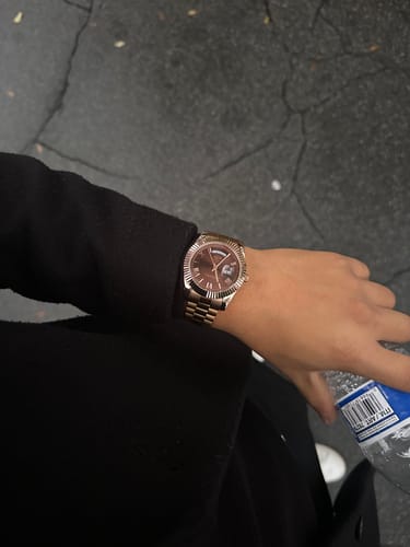 Reviewer showing the rose gold Lucky Fours® Santos watch fitting perfectly on their wrist outdoors.