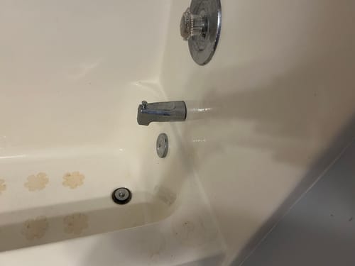 Reviewer's dirty bathtub with stained non-slip stickers before cleaning with the Bathroom Concentrate 4x.