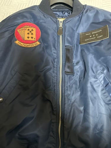 Customer's blue B-15C MOD Flight Jacket, personalized with a name tag and squadron patch on the chest.