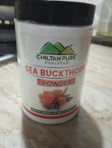 Customer's sealed white jar of Chiltan Pure Sea Buckthorn Powder on a countertop.