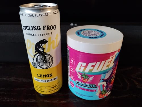 Customer's can of Lemon THC Light Seltzer next to a tub of G Fuel strawberry mix, as mentioned in the review.