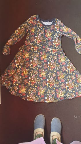 Reviewer's festive dress made from the Sparkly Christmas Decor Cotton Jersey Fabric, laid out flat.