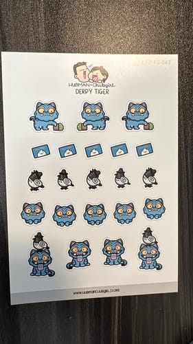 Reviewer's complete sheet of adorable Derpy Tiger Planner Stickers on a wooden surface.