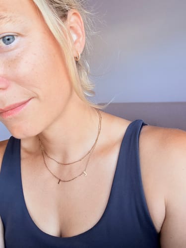 Reviewer wearing the Original Initial Letter Necklace layered with another delicate chain.