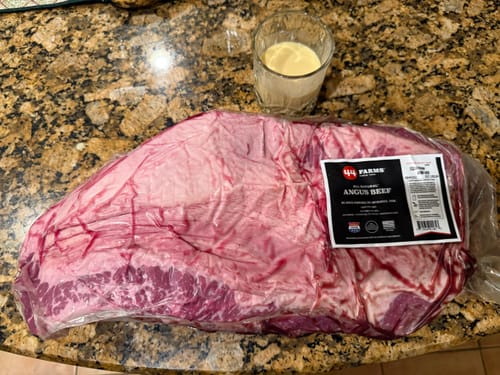 Customer's raw USDA Prime Brisket in its vacuum-sealed packaging on a kitchen counter before cooking.