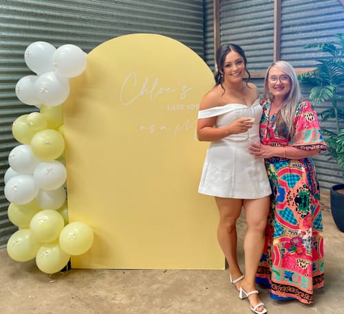 Reviewer wearing the vibrant Cleo Multi Colour Shirt Dress, standing with another person at an event.