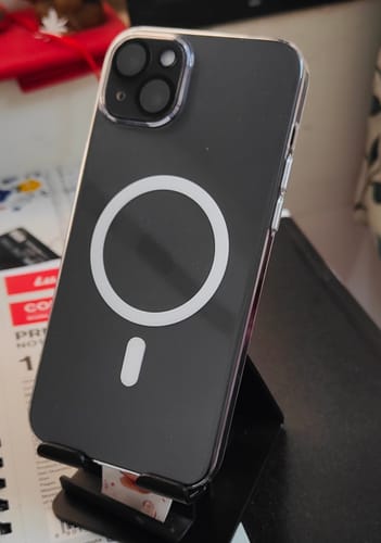 Reviewer's Anti Yellow Clear Case on a dark iPhone, showing the white MagSafe ring and raised camera protection.