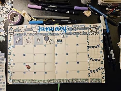 Customer's decorated monthly calendar for January, using penguin and party stickers from the Ultimate Subscription.